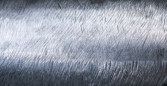 闪亮的表面和不锈钢上的划痕工业白色材料圆形金属曲线拉丝背景图片