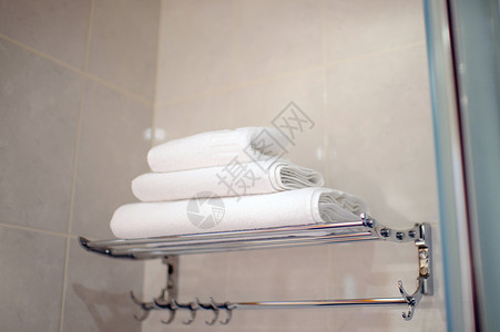 浴室架子旅馆浴室的一堆白毛巾 一套洗浴用的毛巾清洁度身体房间财产架子温泉棉布酒店房子公寓背景