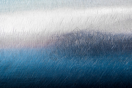 闪亮的表面和不锈钢上的划痕圆形金属白色工业拉丝曲线材料背景图片