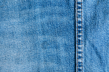 牛仔面料的质地和接缝织物服装蓝色时尚牛仔布纺织品裤子衣服背景图片