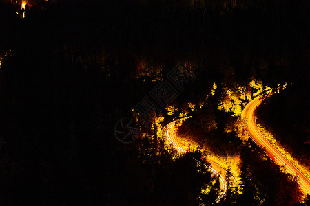 夜晚山上 汽车驾车沿路驶下摇摇欲坠的公路灯高清图片素材
