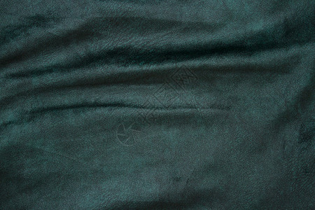 丝绒织物质地 背景 绿色 带有发光光和暗影的天鹅绒丝绒布背景 剧院和时装设计主题的背景纺织品墙纸布料天鹅绒丝绸红宝石布商液体衣服背景图片