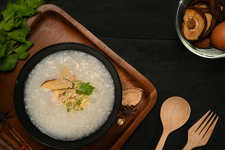 美味大米粥加软煮蛋 芝麻蘑菇 切姜和木碗的扇菜 最高风景背景图片