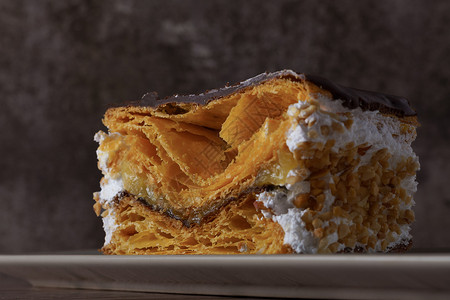 卷心奶油蛋糕巧克力覆盖的奶油和杏仁卷心糕饼背景