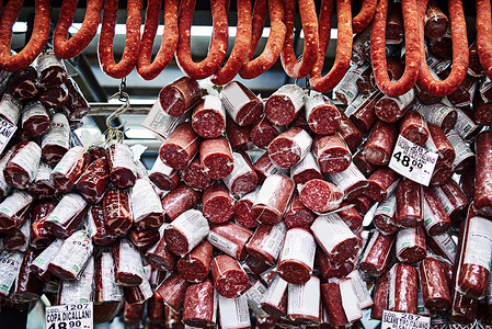 我们也让肉食爱好者开心 不同类型的腌肉在摊位上相互堆叠 白天在市场上出售内饰高清图片素材