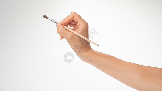 撇捺用女人的右手画笔 用白色背景画图的手势背景