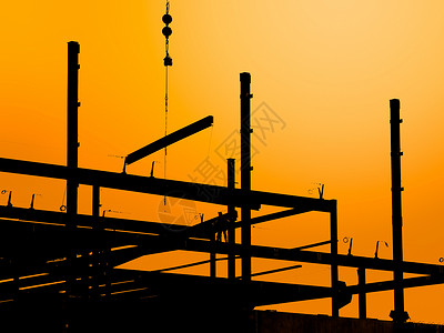 建筑工地建设日落框架金属建筑学外观结构橙子天空光束背景图片