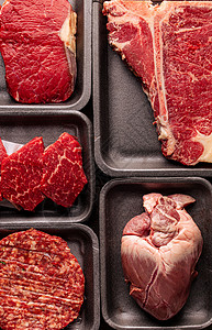 塑料箱中各种生牛肉肉类塑料猪肉店铺美食屠夫内脏盒子黑色产品市场心高清图片素材