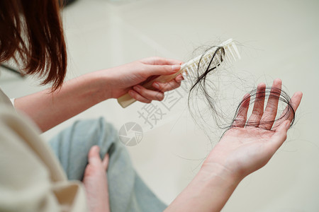 失去亚洲女性在梳子刷上有长脱发的问题化妆品药品损失女士展示诊所头发外貌生长脱发背景