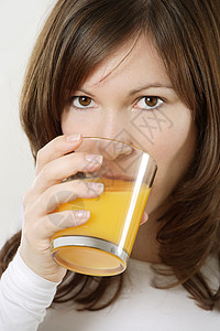 饮橙汁女士水果饮食早餐女性橙子头发黑发玻璃饮料漂亮的高清图片素材