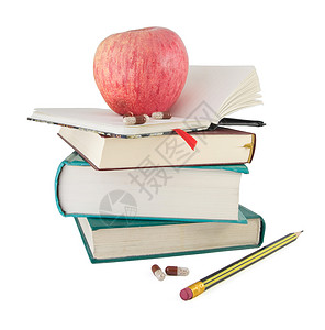 书上的苹果书上的药丸和红苹果办公室饮食铅笔知识食物学习小吃数据水果字典背景