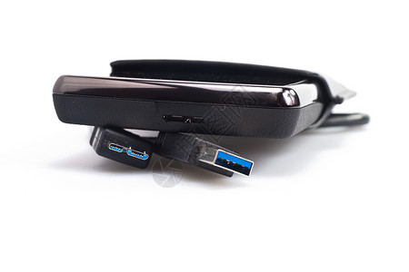 带有USB电缆的便携硬碟笔记本磁盘硬件技术贮存数据店铺电缆备份记录移动的高清图片素材