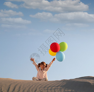 玩气球的小女孩带着多彩气球的快乐小女孩乐趣沙漠女性海滩喜悦孩子沙丘闲暇场地白色背景
