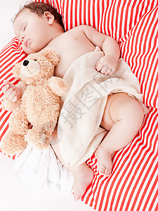 红色条纹枕头睡着的可爱小宝宝 在红色和白条纹枕头上就寝生活男生孩子童年女孩家庭儿子新生压痛背景