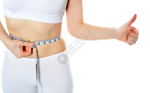 在妇女腰部周围闭紧胶带统治者尺寸数字工作室减肥测量腰围米尺女士女性背景