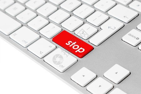 中止带有红色“停止”按钮的计算机键盘背景