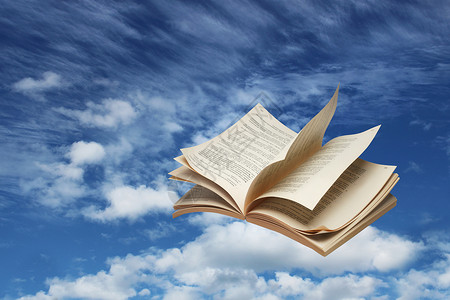 飞起来的书蓝天上飞翔的开放书背景