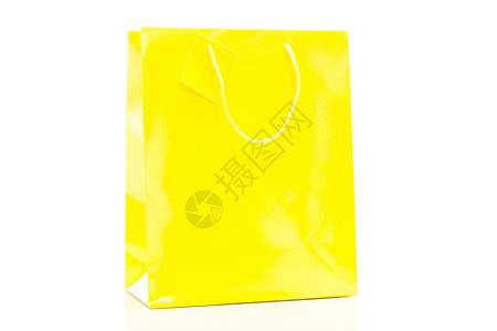 白色背景的单黄色购物袋(白底面)背景图片