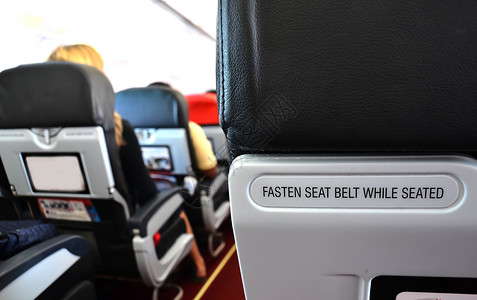 飞机座椅商业旅游旅行航班航空公司喷射运输安全带木板椅子背景图片