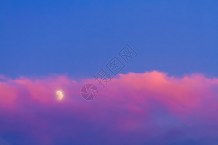 月亮和云蓝色天空中粉红云下的月亮日落天堂多云时间现实粉色月球背景