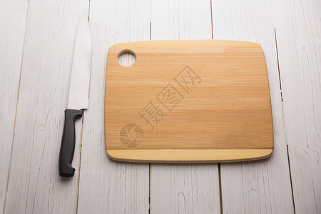 拿着大刀的购物板阴影厨艺切菜板烹饪用具木板美食背景图片