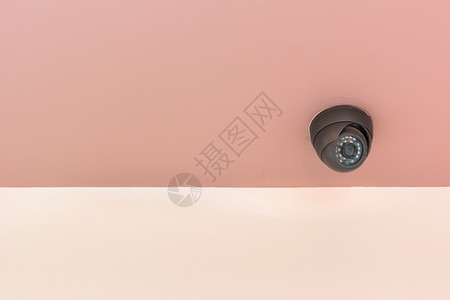 室内混凝土墙上的现代安保摄像头安全监视器间谍危险监视控制预防隐私警卫镜片电的高清图片素材