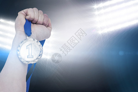 奥运奖牌握着奥运金牌的手贴近领导男性勋章胜利徽章奖章成就聚光灯奖牌游戏背景