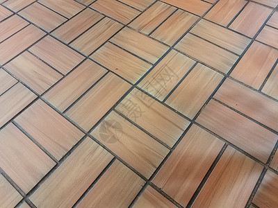 地板或地面上的棕砖形矩形瓷砖图案背景图片