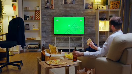 电视线生意人喜欢吃比萨饼的后视线长椅客厅娱乐套装公寓商务电影男人电视屏幕背景