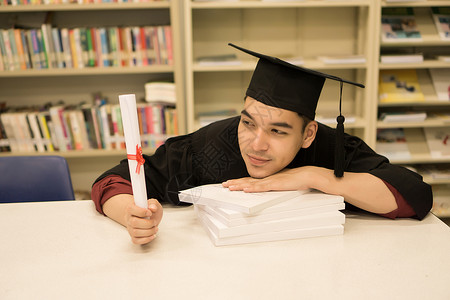 持有毕业证书的快乐研究生手头有文凭 教育学士学位幸福大学男人男性成人成就学生微笑证书帽子袍高清图片素材
