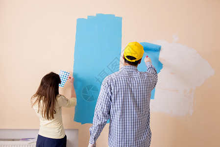 丈夫和妻子在家做家庭装修房间画家画笔装潢团队调色板绘画已婚维修滚筒更新高清图片素材