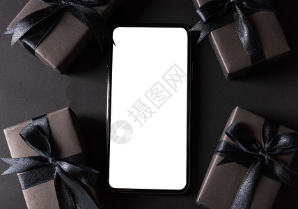 包着黑纸和黑色弓领带的礼盒技术展示卡片盒子假期丝带互联网零售感恩店铺空白的高清图片素材