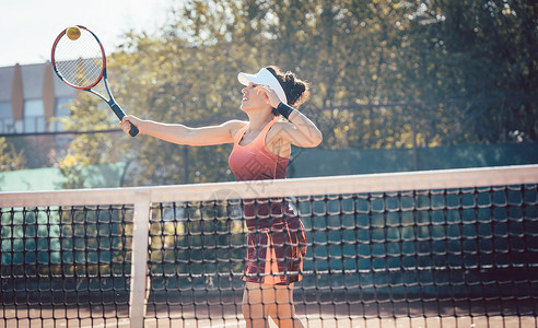 穿红运动服打网球的妇女女士网球场学习玩家网球乐趣老师俱乐部教训运动装背景图片