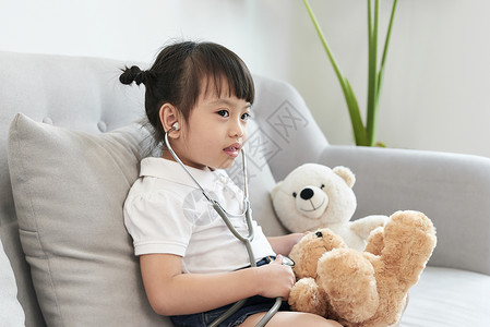 女医生在儿科玩儿和治病保健药品护士卫生孩子孩子们医院童年女孩玩具背景图片