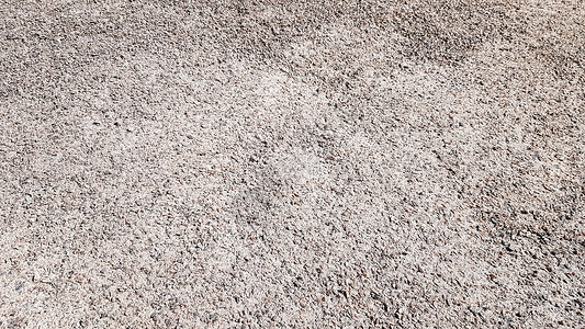 在自然光下被击碎的砾石纹理背景 用于背景或纹理的细灰色砾石 用于道路建设或景观建筑的天然建筑材料 建造业韧性高清图片素材