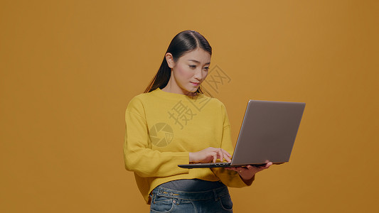 年轻人在手提笔记本电脑上打字 工作室有技术在线的高清图片素材