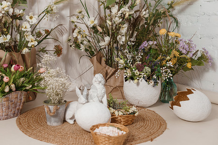 小岛上的兔子室内花卉复活节组成 复活节兔子和一个大蛋壳的小雕像 复活节快乐假期的家居装饰概念花束风格庆典雏菊塑像文化创造力花朵传统插花背景