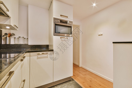 厨房一般视图 以浅色显示装饰财产白色风格烤箱公寓厨具建筑学兜帽橱柜背景图片