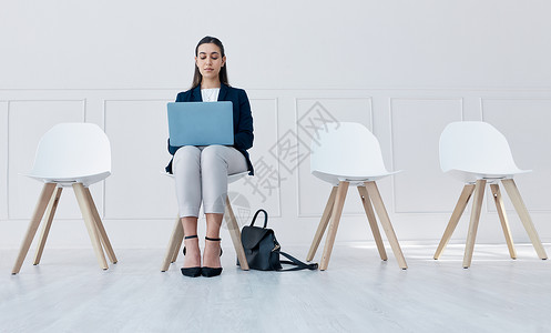 招聘 笔记本电脑和候诊室的女性坐在办公室的椅子上 我们正在招聘或人力资源在线发帖 在企业面试中入围人力资源工作机会的人背景图片