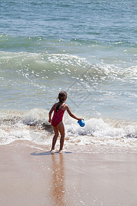 小女孩在海滩上跟一个酒桶玩耍 自然 水 泳装土地高清图片素材