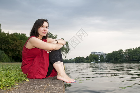 坐在河边的女人 独自的 红色的 户外拍摄 悲伤 裙子 心碎 天空背景图片