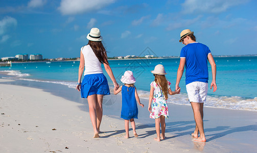 年轻家庭与两个孩子在卡利比恩度假的背影 热带高清图片