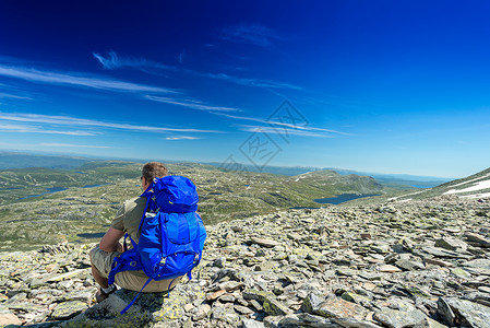 带着大旅行背包的登山者 期待着山地上 假期背景图片