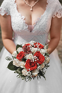 森式婚礼素材新娘穿着婚纱的新娘手里握着装饰式的婚礼花束红白玫瑰 紧紧地放在手上 优雅 快乐的背景