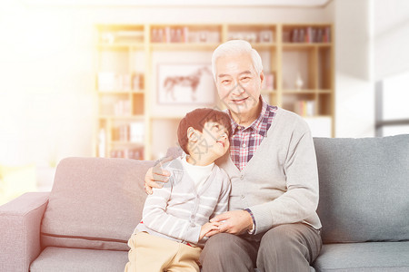 老人和孙子在沙发上坐着孙子陪爷爷休息设计图片