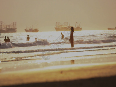 人的背影黄昏海边人群游玩GIF高清图片