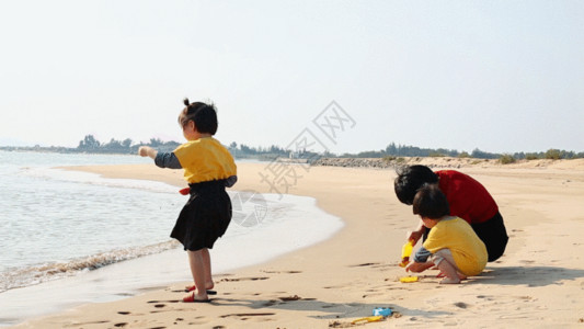 女孩在弹琵琶妈妈带孩子在海边玩沙子GIF高清图片