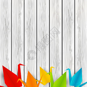 木制背景上的纸折鹤图片