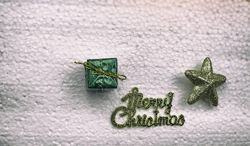 圣诞快乐和金星字母旁边的小礼盒抽象艺术设计背景戏剧色调艺术风格图片