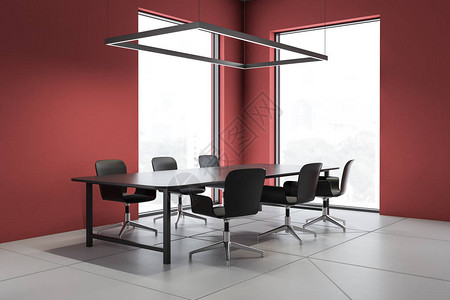 内有红色墙壁白色砖瓦地板黑色长桌和黑椅子的阁楼会议室内部图片